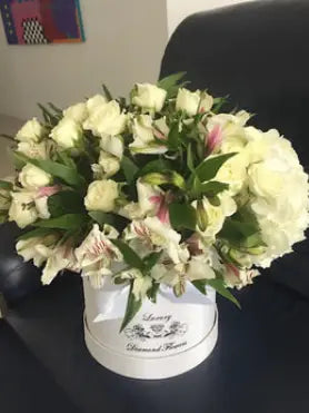 Mix Flower white and greens arrangement last a week or so